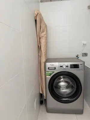 a washer and dryer in a corner of a room at Laginha Apartment in Mindelo