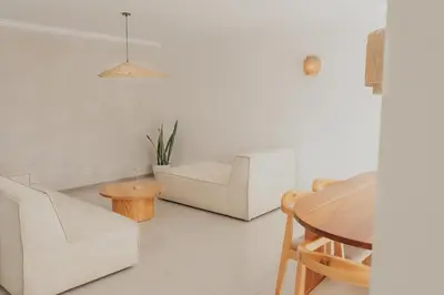 a living room with white furniture and a table at Laginha Apartment in Mindelo