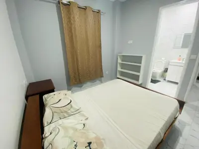 a small bedroom with a bed and a window at Apartamento T2 mobiliado in Mindelo