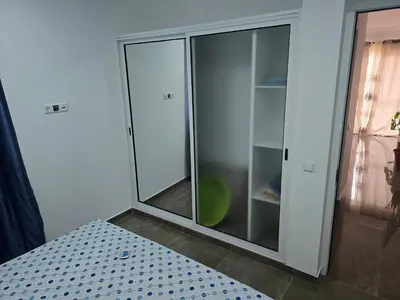 a glass closet with a glass door in a room at Apartamento Inteiro Porto Novo Abufador in Porto Novo