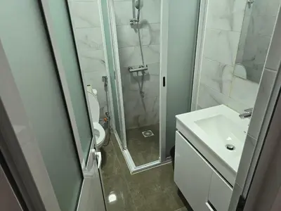 a bathroom with a shower and a toilet and a sink at Apartamento Inteiro Porto Novo Abufador in Porto Novo