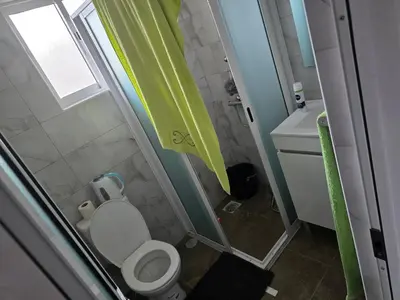 a small bathroom with a toilet and a sink at Apartamento Inteiro Porto Novo Abufador in Porto Novo