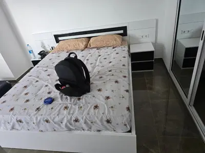 a backpack sitting on a bed in a bedroom at Apartamento Inteiro Porto Novo Abufador in Porto Novo