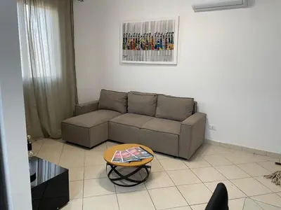 a living room with a couch and a table at Larriba Santa Maria by RPG Group in Santa Maria