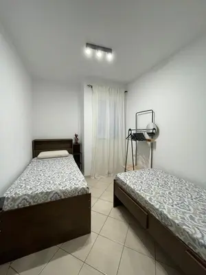 a bedroom with two beds and a window at Larriba Santa Maria by RPG Group in Santa Maria