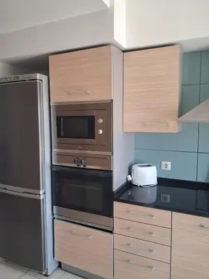 a kitchen with a refrigerator and a microwave at Vila Verde Ficus in Santa Maria