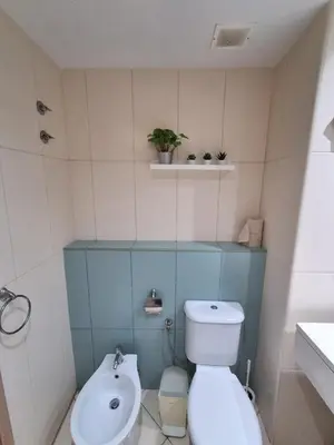 a small bathroom with a toilet and a sink at Vila Verde Ficus in Santa Maria