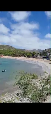 a beach with a group of people in the water at Casa do Céu Azul in Tarrafal