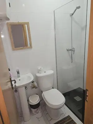 a bathroom with a toilet and a sink and a shower at Casa do Céu Azul in Tarrafal