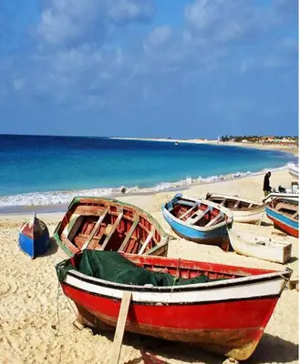 a group of boats sitting on the beach at Comfortable 1-bedroom 400 meters from the beach with Fast Wi-Fi in Santa Maria