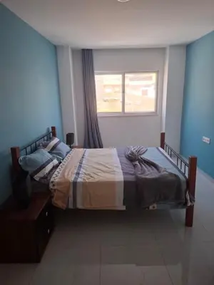 a large bed in a bedroom with a window at Tdois in Praia