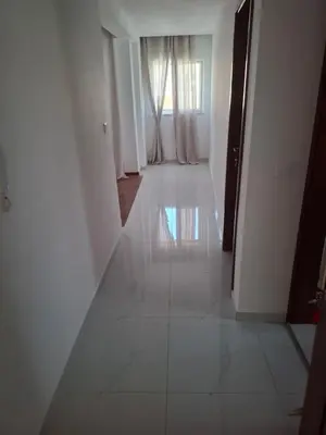 a hallway with a white floor and a window at Tdois in Praia