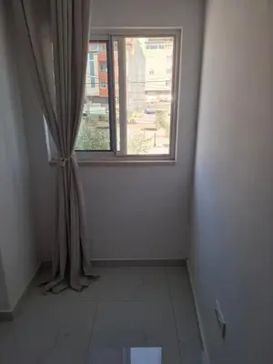a room with a window and a tiled floor at Tdois in Praia