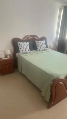 a bedroom with a large bed and a window at Natflor in Praia