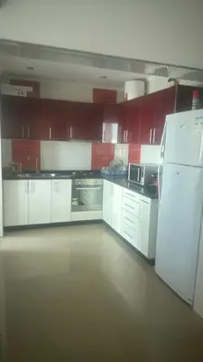 a kitchen with white cabinets and a white refrigerator at Natflor in Praia