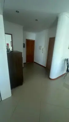 an empty room with a hallway with two doors and a chair at Natflor in Praia