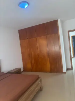 a bedroom with a wooden cabinet and a bed at Ocean of View in Mindelo