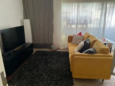 a living room with a couch and a television at City View Apartment in Praia