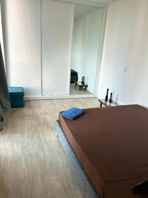 a bedroom with a bed and a room with a mirror at City View Apartment in Praia