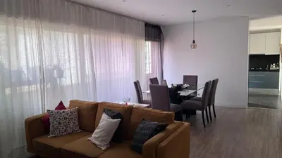 a living room with a couch and a dining room at City View Apartment in Praia
