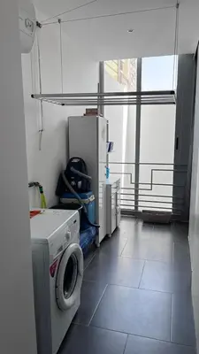 a laundry room with a washing machine and a window at City View Apartment in Praia