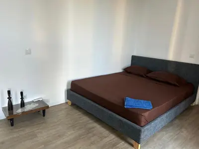 a bedroom with a bed with a blue pillow on it at City View Apartment in Praia