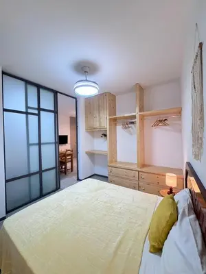 a bedroom with a large bed and a large window at Bounty Apartment Santa Maria by RPG Group in Santa Maria