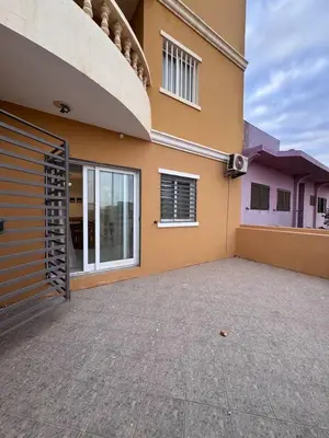 a house with a garage door and a building at Bounty Apartment Santa Maria by RPG Group in Santa Maria