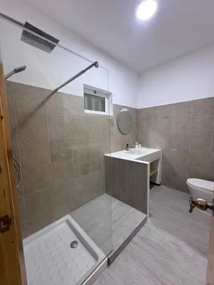 a bathroom with a shower and a toilet and a sink at Bounty Apartment Santa Maria by RPG Group in Santa Maria