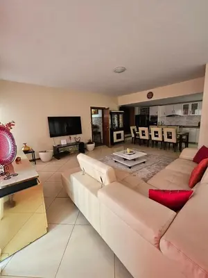 a living room with a couch and a tv at Casa América in Praia