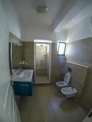 a bathroom with two sinks and a shower and two toilets at Surf House Cabo Verde in Santa Maria