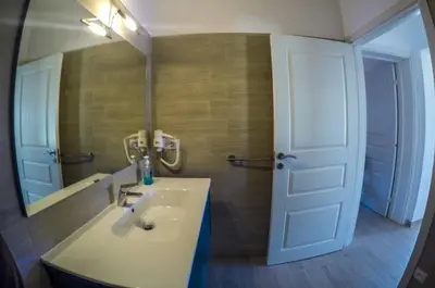 a bathroom with a sink and a mirror at Surf House Cabo Verde in Santa Maria