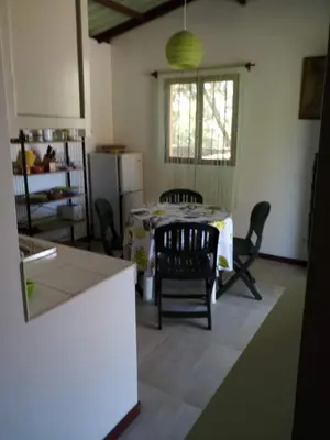 a kitchen with a table and chairs in a room at Coin de Paradis,Pavillon Doucimar in Porto Novo
