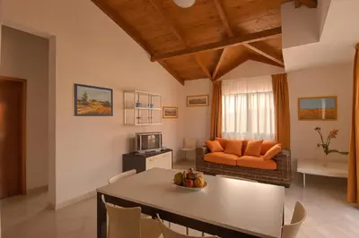 a living room with a table and a couch at Aparthotel Ponta Preta in Santa Maria