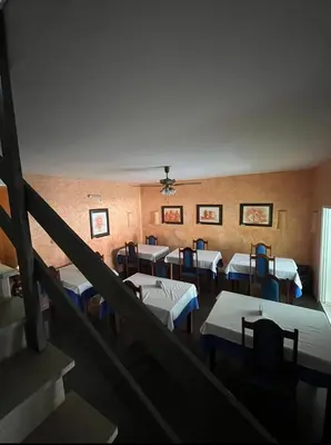 a room with a bunch of beds in it at Vivenda Viviani in Praia