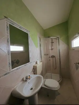 a bathroom with a sink and a toilet and a shower at Vivenda Viviani in Praia