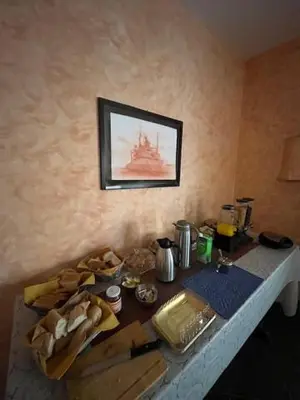 a table with food and a picture of a ship on the wall at Vivenda Viviani in Praia