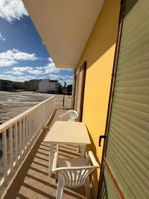 a balcony with a table and chairs on it at Pedra do Sol Praia Estoril Sal Rei FREE WI-FI in Sal Rei