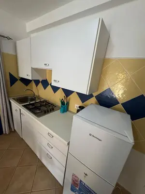 a kitchen with a stove and a box in it at Holiday Properties Tres Caravelas in Santa Maria