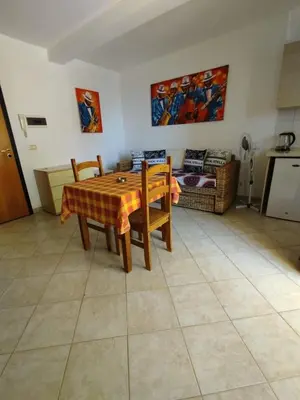 a dining room with a table and chairs and a couch at Holiday Properties Tres Caravelas in Santa Maria