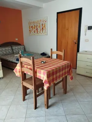 a room with a table and chairs and a bed at Holiday Properties Tres Caravelas in Santa Maria