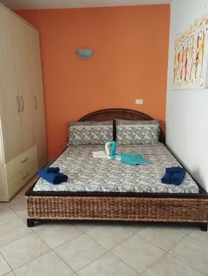 a bedroom with a bed with two towels on it at Holiday Properties Tres Caravelas in Santa Maria