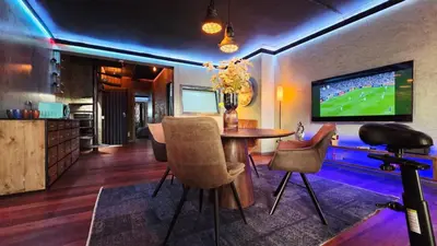 a living room with a table and a tv at Ocean Suites in Santa Maria