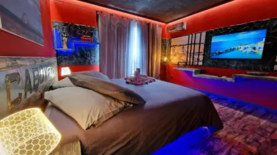 a bedroom with a large bed and a television at Ocean Suites in Santa Maria