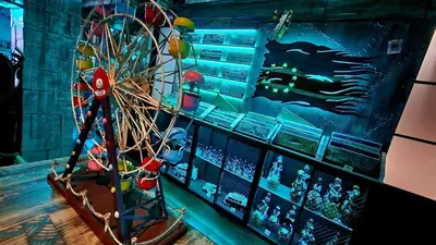 a ferris wheel in a room with a game at Ocean Suites in Santa Maria