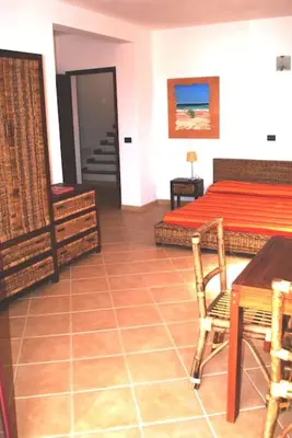 a bedroom with a bed and a table and chairs at Holiday Properties Oleandro Ocean in Santa Maria