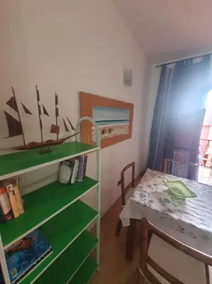 a small room with a table and a green shelf at Holiday Properties Oleandro Ocean in Santa Maria