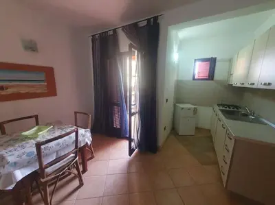 a kitchen with a table and a table and a sink at Holiday Properties Oleandro Ocean in Santa Maria