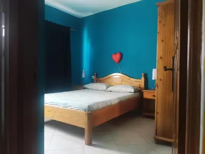 a bedroom with a bed with a red heart on the wall at Ca' Francisca in Santa Maria