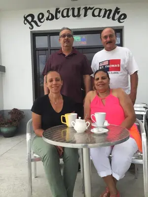 a group of people sitting around a table at Hotel Cruz Grande-Brava in Vila Nova Sintra